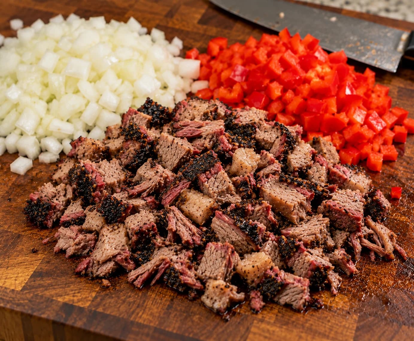 Hand-cut smoked brisket with chopped white onions and red bell peppers