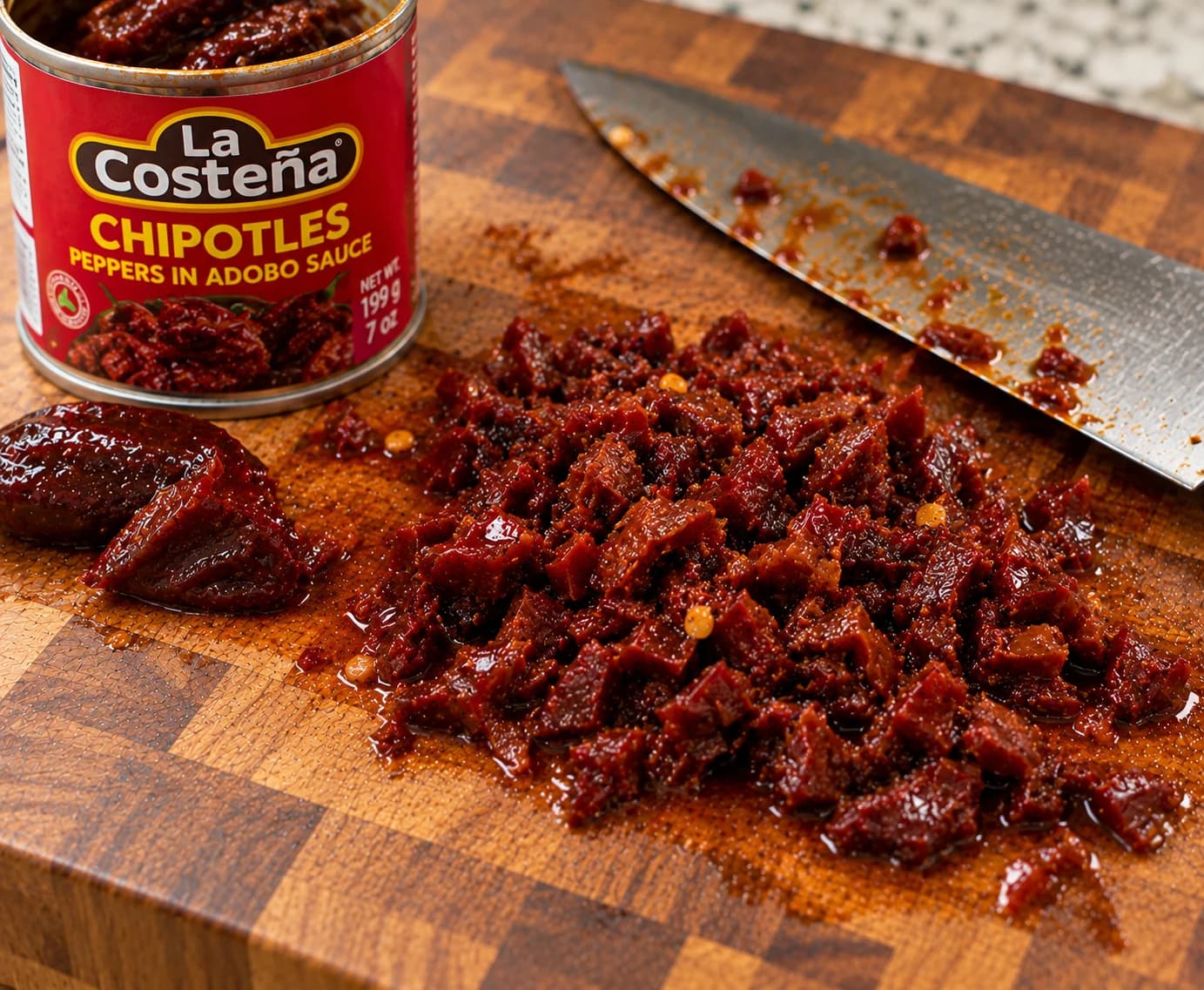 Chopped chipotle peppers in adobo on a cutting board