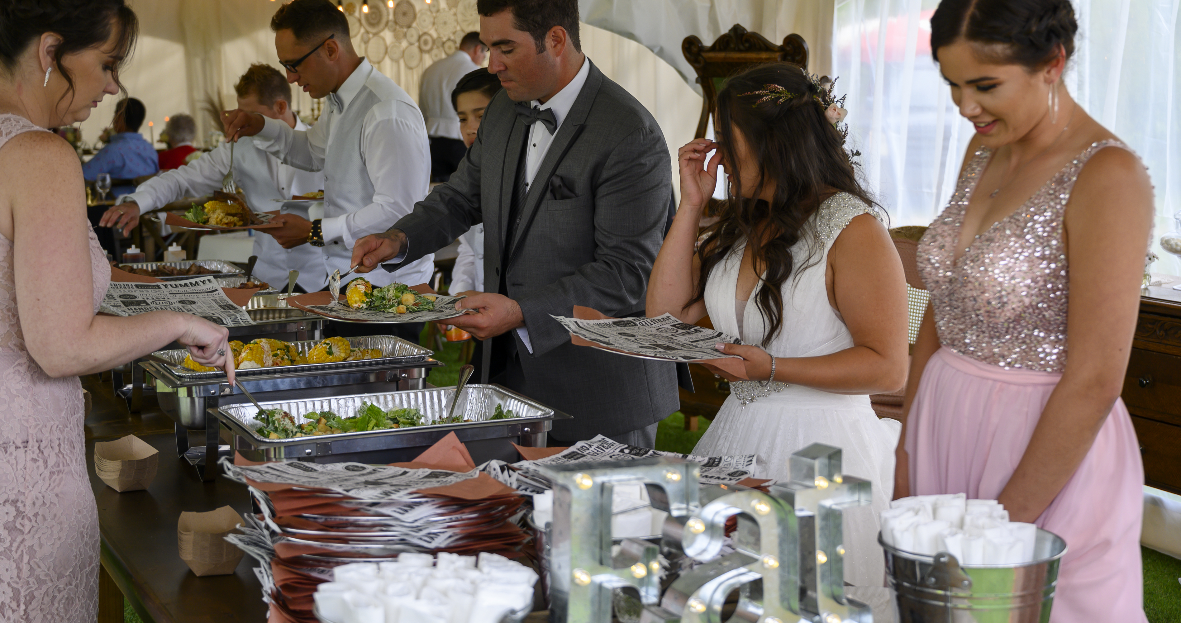 Wedding couple and guests being served Back Forty Barbeque buffet-style